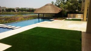 Installed artificial grass on residential property beside pool overlooking a waterfront view